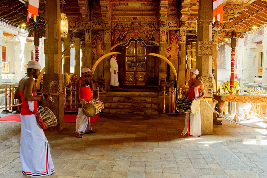Drummers and offerings inside the Temple of the Sacred Tooth during the midday Thevava