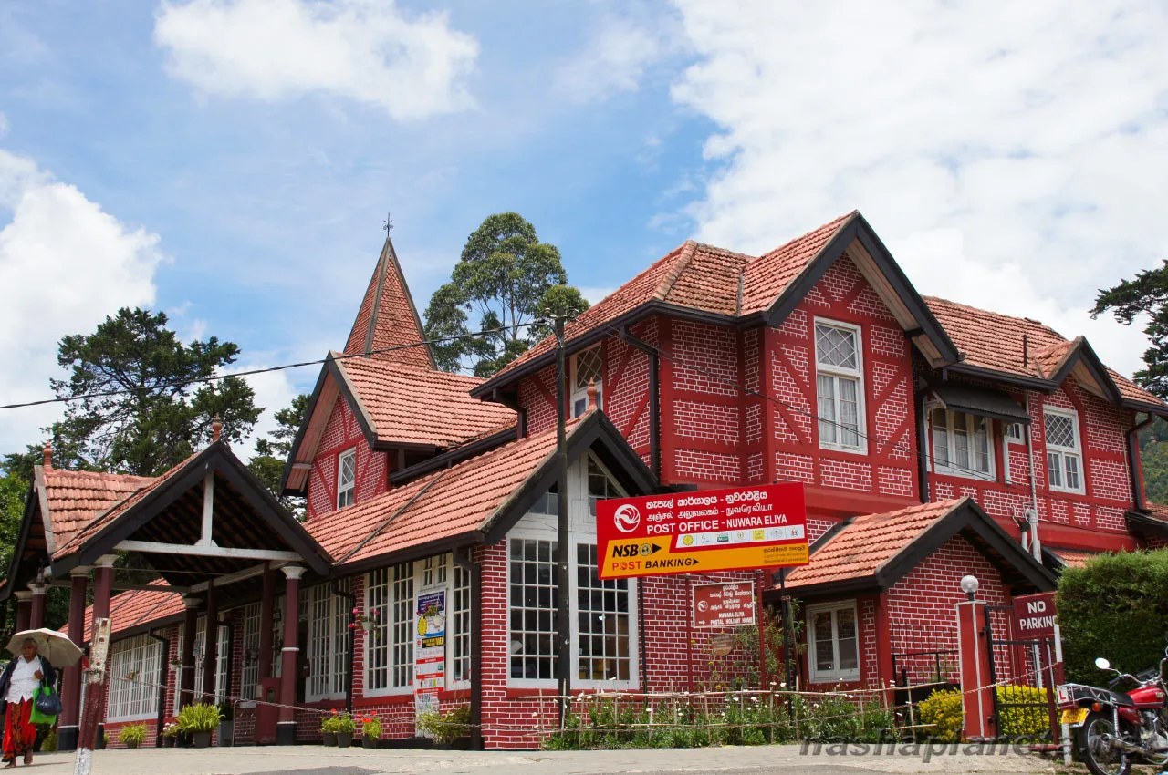 The red brick and timber Victorian post office at Nuwara Eliya, its clock tower against a grey hill sky