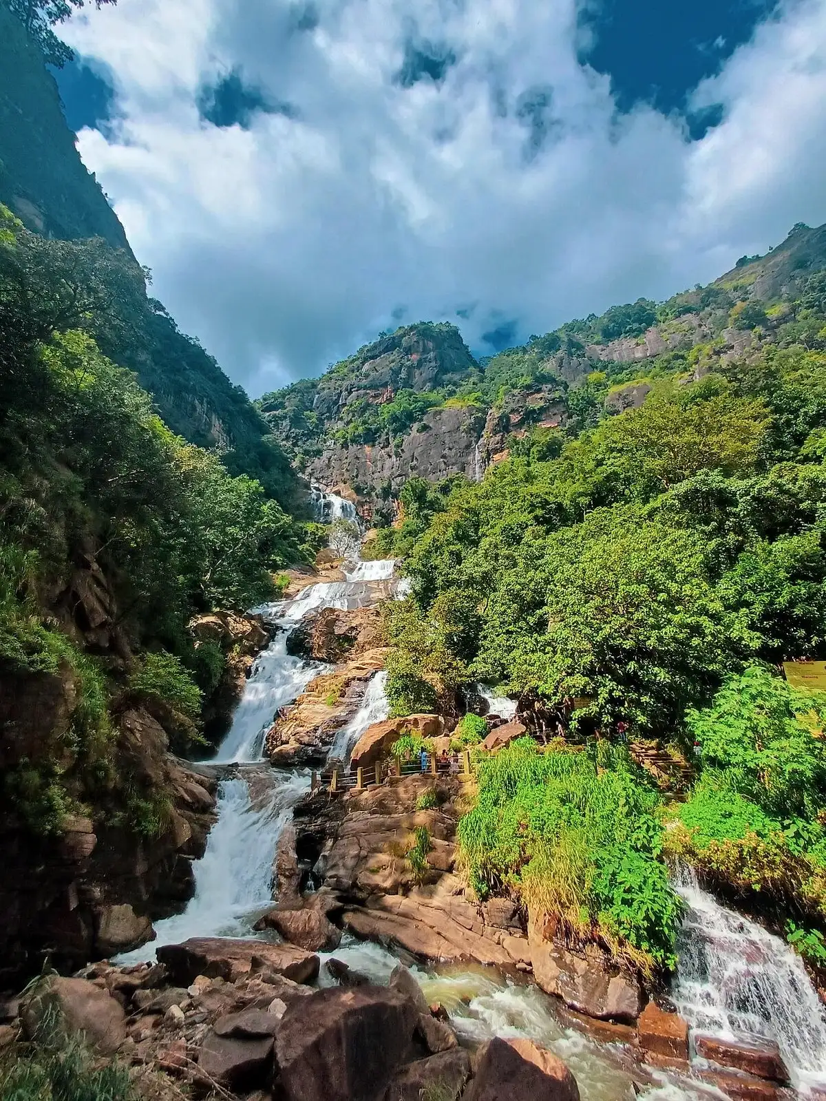 Ravana Falls dropping in wide sheets over dark rock beside the Ella road